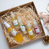 five mayella skincare products in a cardboard gift box that is filled with straw