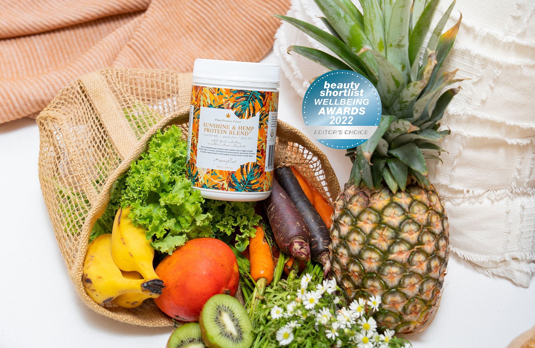 Mayella Sunshine & Hemp Protein sitting in a mesh shopping bag with fresh fruits and vegetables market haul