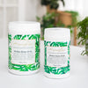 two tubs of alkalise green and go on a white bench tip next to a green overflowing pot plant