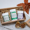 Wheatgrass Capsules, Alkalise Green & Go and Acai Berry Beautiful packed in a cardboard gift box with a bamboo straw with two gold-painted pine cones in the front