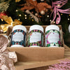 three organic teas packed in a cardboard gift box with a christmas tree in the background